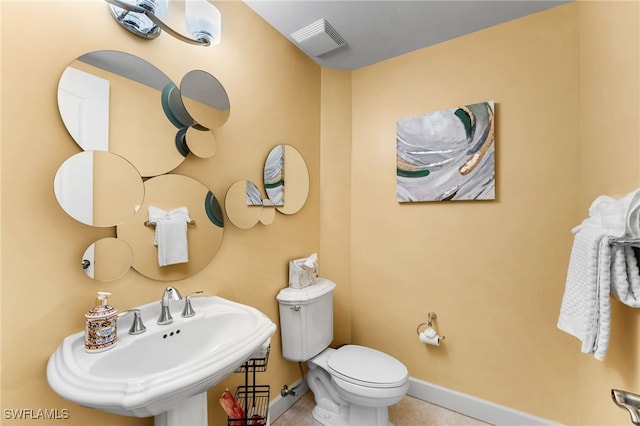 bathroom featuring tile patterned floors, toilet, and sink