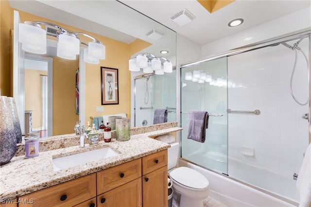 full bathroom with combined bath / shower with glass door, vanity, and toilet