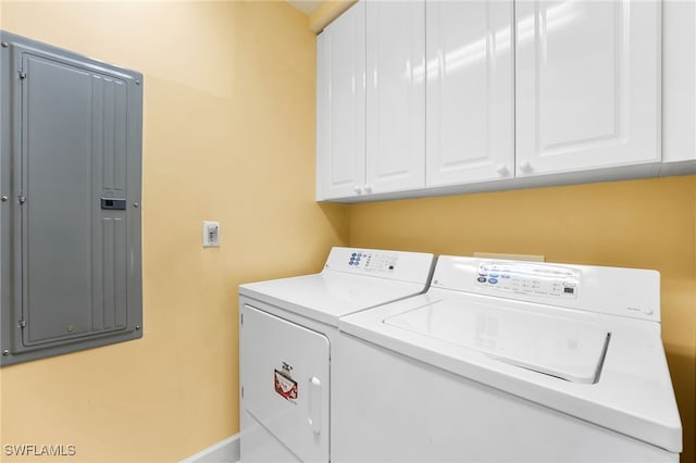 laundry room with cabinets, electric panel, and washing machine and clothes dryer