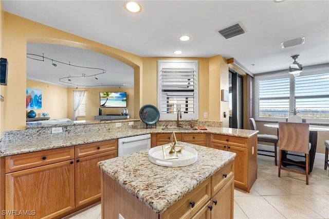 kitchen featuring a center island, kitchen peninsula, sink, and white dishwasher