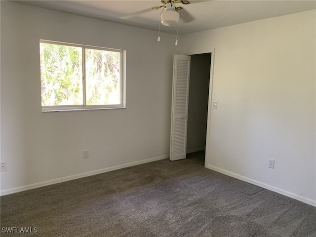 carpeted empty room featuring ceiling fan