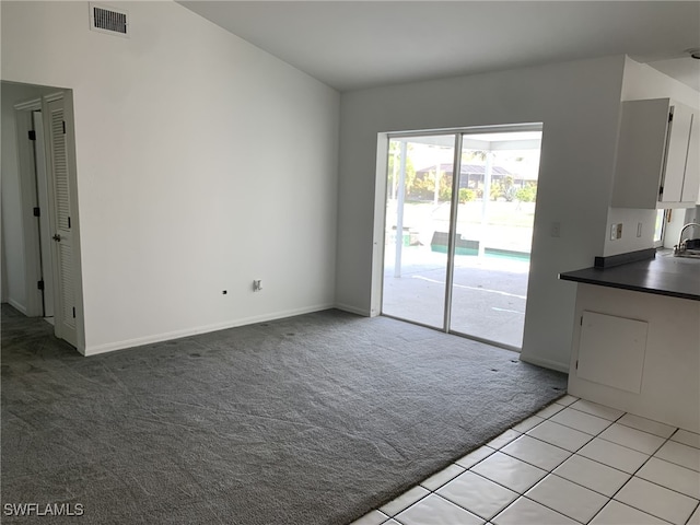 interior space featuring light carpet and sink