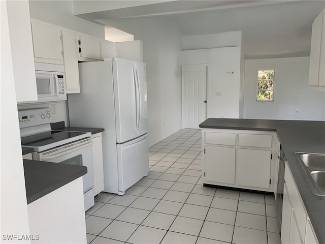 kitchen featuring kitchen peninsula, white appliances, sink, light tile patterned floors, and white cabinetry