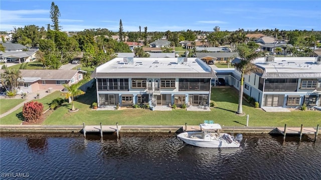 rear view of property featuring a sunroom and a water view