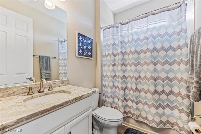 full bathroom featuring shower / tub combo with curtain, vanity, and toilet