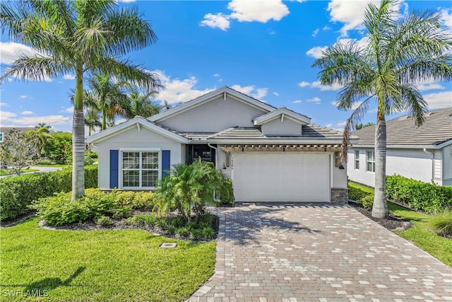 single story home with a garage and a front lawn