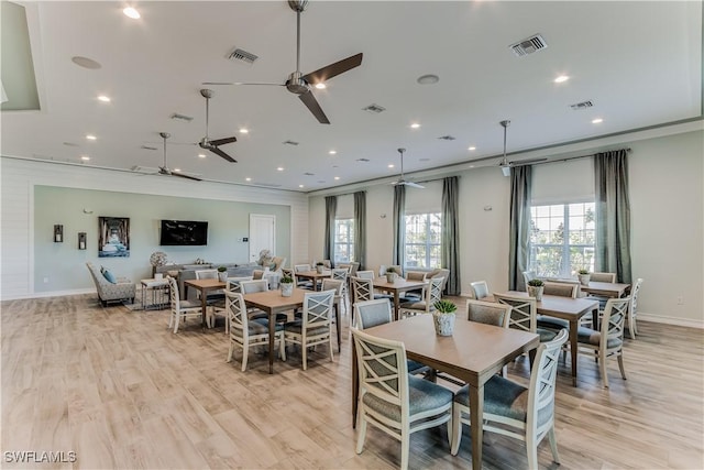 dining room featuring light wood-style flooring and visible vents