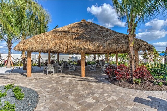 view of home's community with a gazebo, fence, and a patio