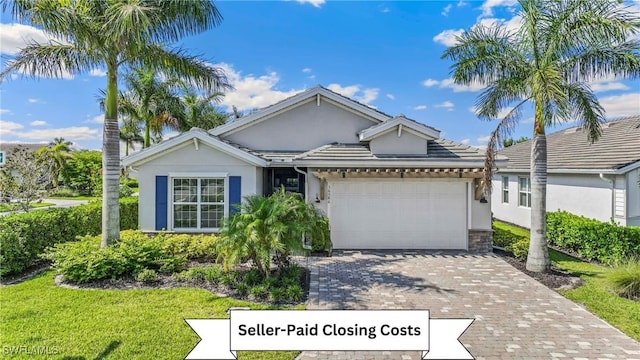 ranch-style house with a garage, a front lawn, decorative driveway, and stucco siding