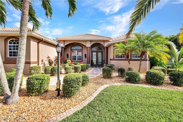 mediterranean / spanish-style home with a front yard