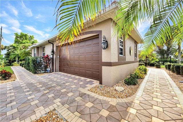 view of property exterior featuring a garage and a balcony