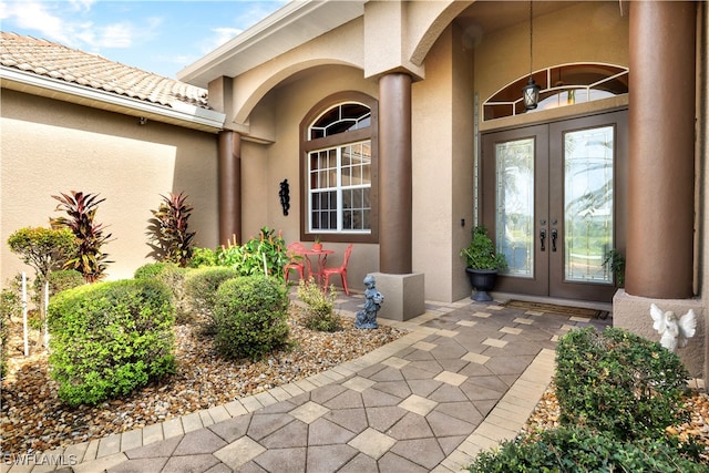 view of exterior entry featuring french doors