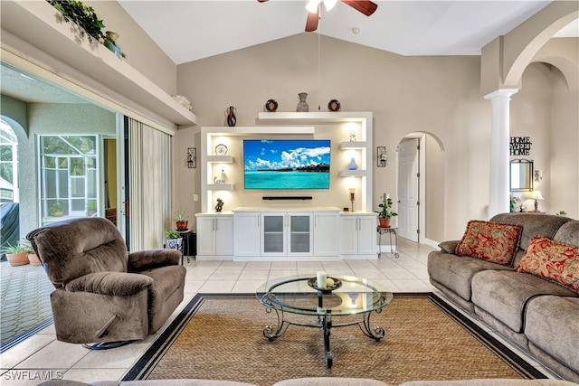 tiled living room with high vaulted ceiling, ornate columns, and ceiling fan