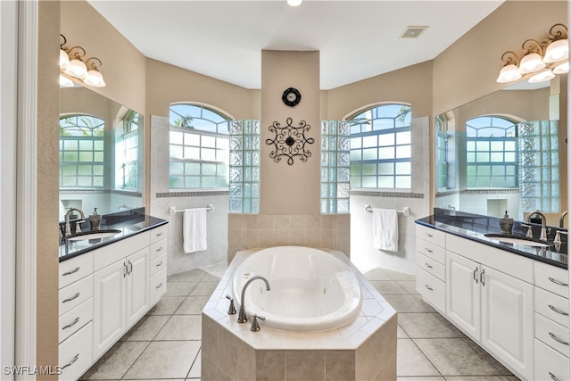 bathroom with a wealth of natural light, tile patterned flooring, and vanity