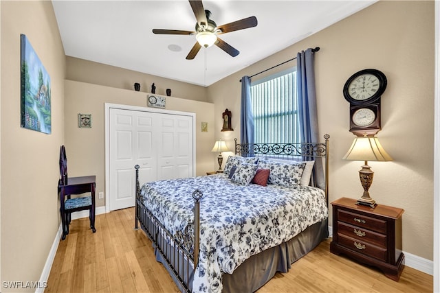 bedroom with a closet, ceiling fan, and light hardwood / wood-style flooring