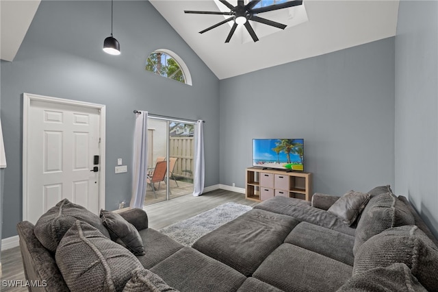 living room featuring high vaulted ceiling, light hardwood / wood-style flooring, and ceiling fan