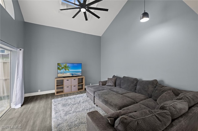 living room with ceiling fan, plenty of natural light, high vaulted ceiling, and hardwood / wood-style flooring