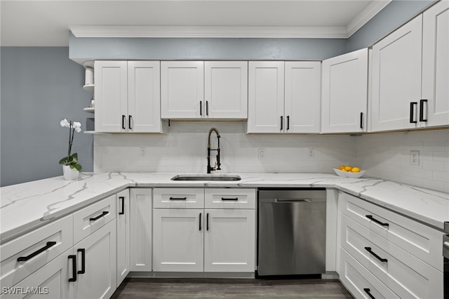 kitchen with stainless steel dishwasher, white cabinets, light stone countertops, and sink