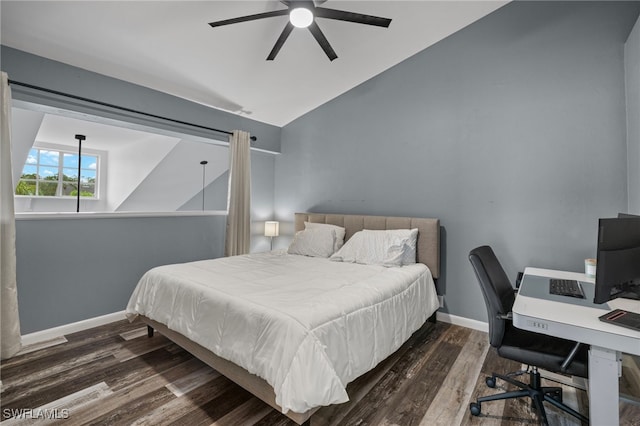 bedroom with dark hardwood / wood-style floors, vaulted ceiling, and ceiling fan