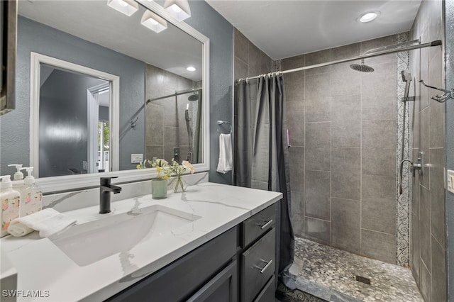 bathroom featuring vanity and curtained shower