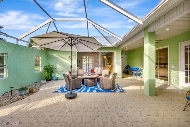 view of patio / terrace featuring a lanai, an outdoor living space, and ceiling fan