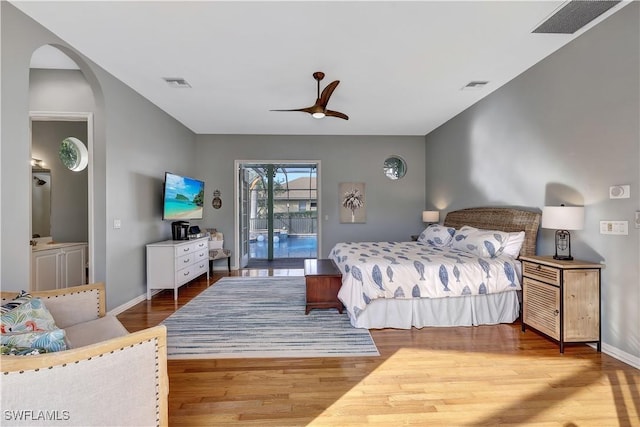 bedroom with access to exterior, visible vents, and wood finished floors