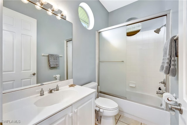 full bathroom with tile patterned floors, vanity, toilet, and bath / shower combo with glass door