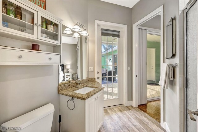 bathroom with vanity, hardwood / wood-style flooring, and toilet