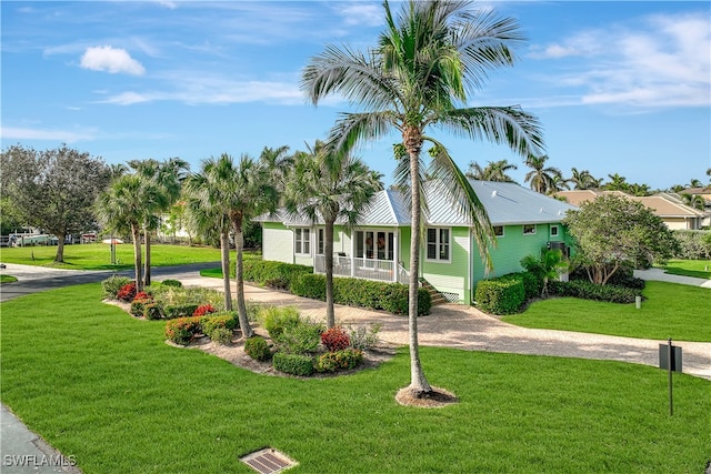 view of front of home featuring covered porch and a front lawn