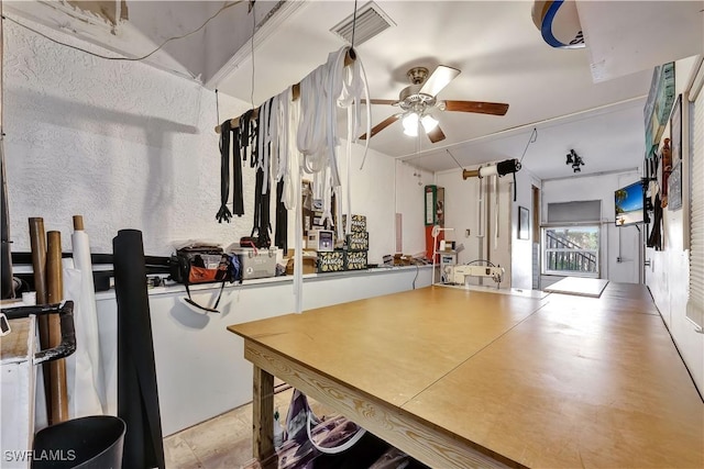 exercise room featuring visible vents and a ceiling fan