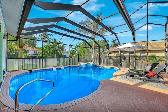 view of pool with glass enclosure, a patio area, and an in ground hot tub