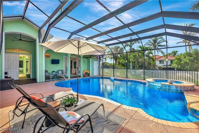 view of swimming pool with a lanai, an in ground hot tub, ceiling fan, and a patio