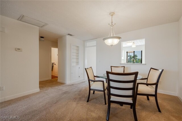 view of carpeted dining space