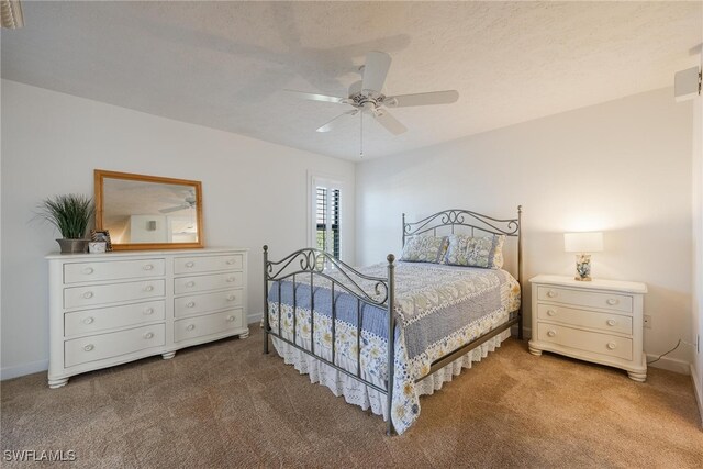 bedroom featuring carpet, a textured ceiling, and ceiling fan