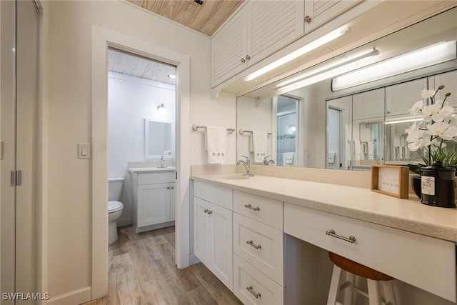 4914 Tudor Dr Unit 203, Cape Coral, FL 33904 - full bathroom with wood finished floors, toilet, and vanity