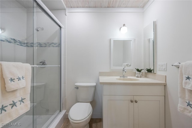 bathroom featuring hardwood / wood-style floors, vanity, toilet, and an enclosed shower