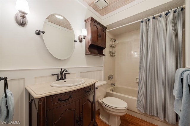 full bathroom with shower / tub combo, vanity, crown molding, wood-type flooring, and toilet