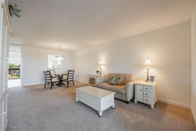 carpeted living room featuring a textured ceiling