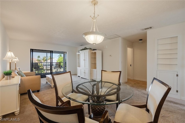 dining area with carpet flooring and a textured ceiling