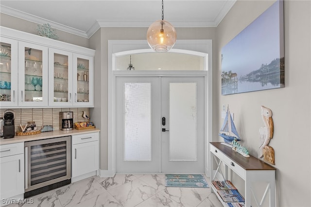 entryway with bar area, ornamental molding, beverage cooler, and french doors