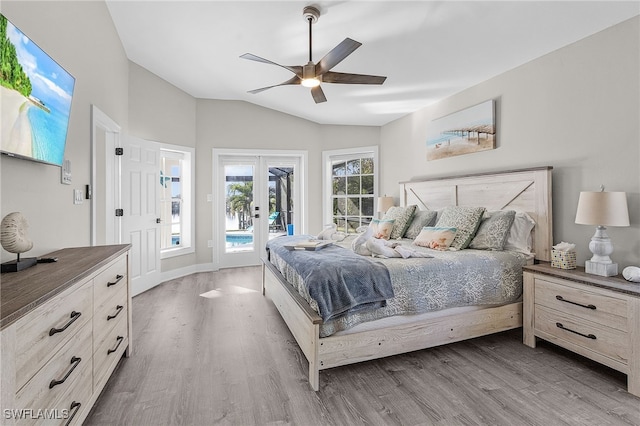 bedroom with access to outside, ceiling fan, wood-type flooring, and vaulted ceiling