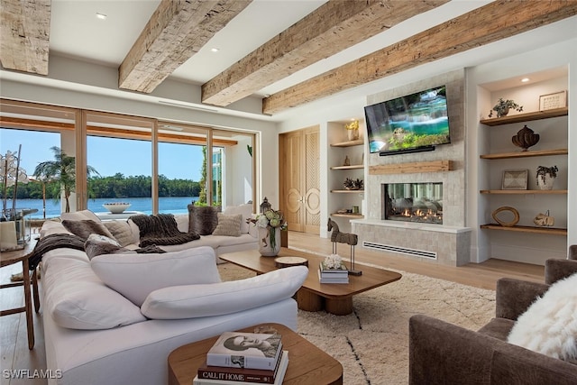 living area featuring light wood-style floors, built in shelves, beam ceiling, and a multi sided fireplace