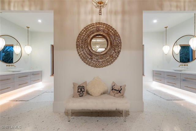 hallway featuring a sink and recessed lighting