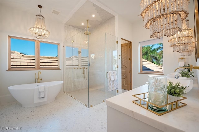 full bath with a chandelier, a sink, visible vents, a freestanding bath, and a shower stall