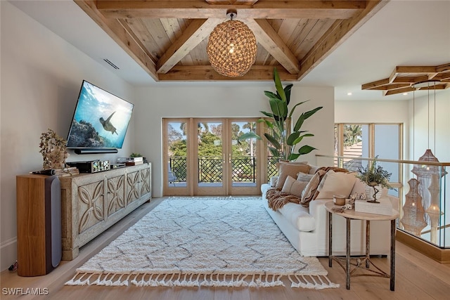 living area featuring light wood finished floors, a wealth of natural light, wooden ceiling, and beam ceiling