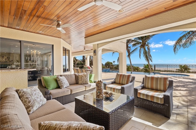 view of patio featuring ceiling fan, a water view, and an outdoor hangout area