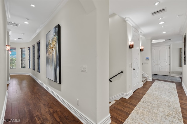 hallway featuring dark hardwood / wood-style flooring and crown molding