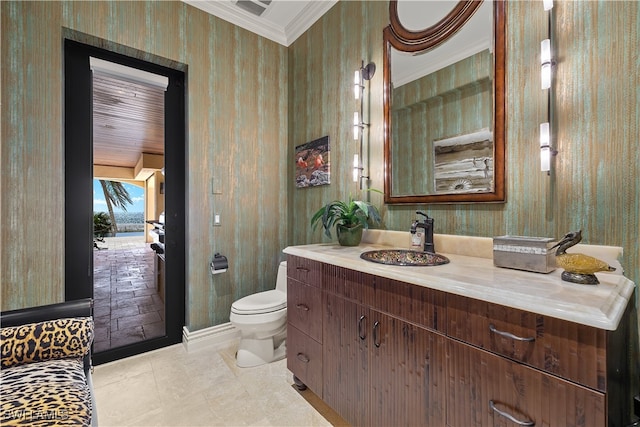 bathroom featuring tile patterned floors, crown molding, vanity, and toilet