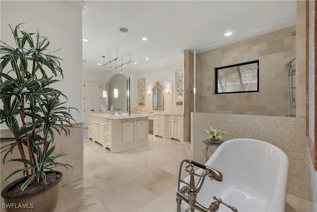 bathroom with crown molding, a washtub, vanity, and tile walls