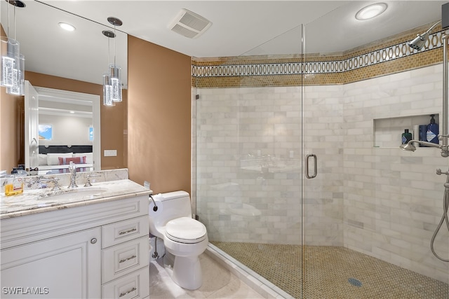 bathroom featuring vanity, a shower with shower door, and toilet